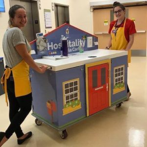 Volunteers serving families with the RMCH cart in the hospital.